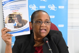 Caribbean Examinations Council (CXC) Director of Operations, Dr. Nicole Manning, displays a copy of the School-Based Assessment (SBA) Concession document, during Wednesday’s (January 7) CXC Press Conference, held at the Overseas Examinations Commission (OEC), in Kingston.