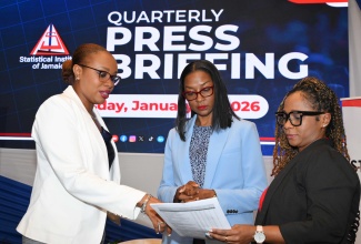 Director General, Statistical Institute of Jamaica (STATIN), Leesha Delatie-Budair (left); Deputy Director General (Acting) and Director, Surveys Division, STATIN, Dr. Natalee Simpson (centre), and Director (Acting) Administrative Statistics, STATIN, Siomara McDonald, peruse a document at STATIN’s quarterly press briefing, held at the AC Hotel in St. Andrew, on January 15.

