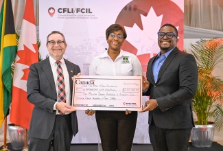 Patron of the Save our Boys and Girls Foundation and Member of Parliament for St. Andrew East Rural, the Most Hon. Juliet Holness (centre), and EduFocal co-founder and Chief Executive Officer (CEO), Gordon Swaby (right), receive a cheque from High Commissioner of Canada to Jamaica, His Excellency Mark Berman, during the Canada Fund for Local Initiatives (CFLI) Spotlight Event, held at the Terra Nova All-Suite Hotel in Kingston, on Thursday (January 22).

