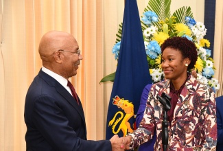 Governor-General, His Excellency the Most Hon. Sir Patrick Allen (left), greets the 2026 Rhodes Scholar, Tiana Dinham, at a recent ceremony, held at King’s House in St. Andrew, to announce the scholarship.

