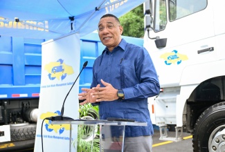 Prime Minister, Dr. the Most Hon. Andrew Holness, delivers the keynote address during the handover ceremony for 10 new tipper trucks to the National Solid Waste Management Authority (NSWMA), held at the agency’s headquarters in Kingston on December 23.

