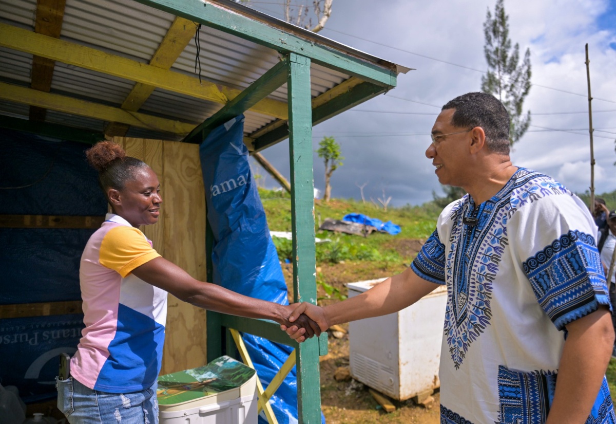Prime Minister, Dr. the Most Hon. Andrew Holness, greets resident of Accompong, St. Elizabeth, Coleen Hutchinson, during a tour of homes in the area on Tuesday (January 6). Ms. Hutchinson is among residents who have benefited from roof repair works being conducted in the community by the Jamaica Defence Force (JDF). 