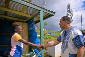 Prime Minister, Dr. the Most Hon. Andrew Holness, greets resident of Accompong, St. Elizabeth, Coleen Hutchinson, during a tour of homes in the area on Tuesday (January 6). Ms. Hutchinson is among residents who have benefited from roof repair works being conducted in the community by the Jamaica Defence Force (JDF). 