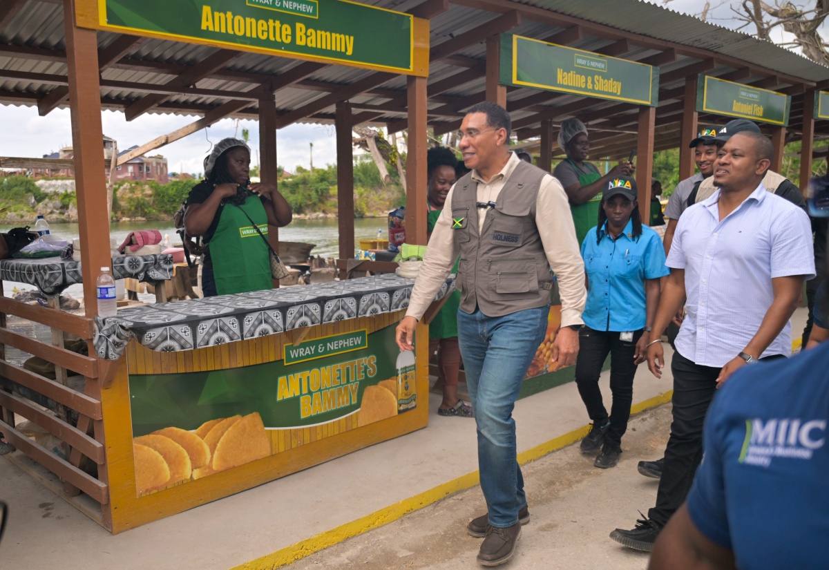  Prime Minister, Dr. the Most Hon. Andrew Holness  (left) tours the grounds of the popular Border roadside eatery in St. Elizabeth, following the official ceremony to reopen the 44 shops at the facility on January 16. He is accompanied by Minister of Agriculture, Fisheries and Mining, Hon. Floyd Green.
