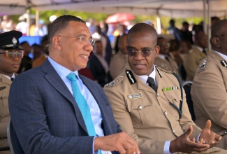 Prime Minister, Dr. the Most Hon Andrew Holness (left), conversing with Police Commissioner, Dr. Kevin Blake, during the Jamaica Constabulary Force (JCF) passing out parade and awards ceremony at the National Police College of Jamaica (NPCJ) in Twickenham Park, St. Catherine, on January 21. 

