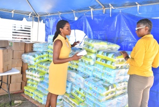 Chief Executive Officer at the Black River Hospital in St. Elizabeth, Diana Brown Miller  (right) and Paediatrician at the facility, Dr. Allison Isaacs,  look at infant and maternity supplies donated to the hospital by the Digicel Foundation. The items, valued at $1.3 million,  were handed over at the hospital on Thursday ( Jan. 15).