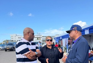 Minister of State in the Ministry of Health and Wellness, Hon. Krystal Lee, converses with Deputy Mayor of Montego Bay, Councillor Dwight Crawford (left), and Western Regional Health Authority (WRHA) Regional Director, St. Andrade Sinclair, during the WRHA Healthcare Workers’ Support Fair at Pier 1 in Montego Bay, St. James, on Friday (January 9).

