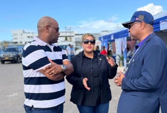 Minister of State in the Ministry of Health and Wellness, Hon. Krystal Lee, converses with Deputy Mayor of Montego Bay, Councillor Dwight Crawford (left), and Western Regional Health Authority (WRHA) Regional Director, St. Andrade Sinclair, during the WRHA Healthcare Workers’ Support Fair at Pier 1 in Montego Bay, St. James, on Friday (January 9).