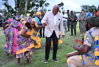 Minister of Foreign Affairs of the Republic of Ghana, His Excellency Samuel Okudzeto Ablakwa (centre), dances with the Charles Town Maroon group during a welcome reception and tour at the Seville Great House in St. Ann, on Sunday (January 25). Observing in the background is Jamaica