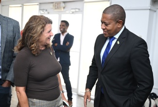  Minister of Agriculture, Fisheries and Mining, Hon. Floyd Green (right), is in conversation with President, American Friends of Jamaica (AFJ), Wendy Hart, at the official launch of AFJ