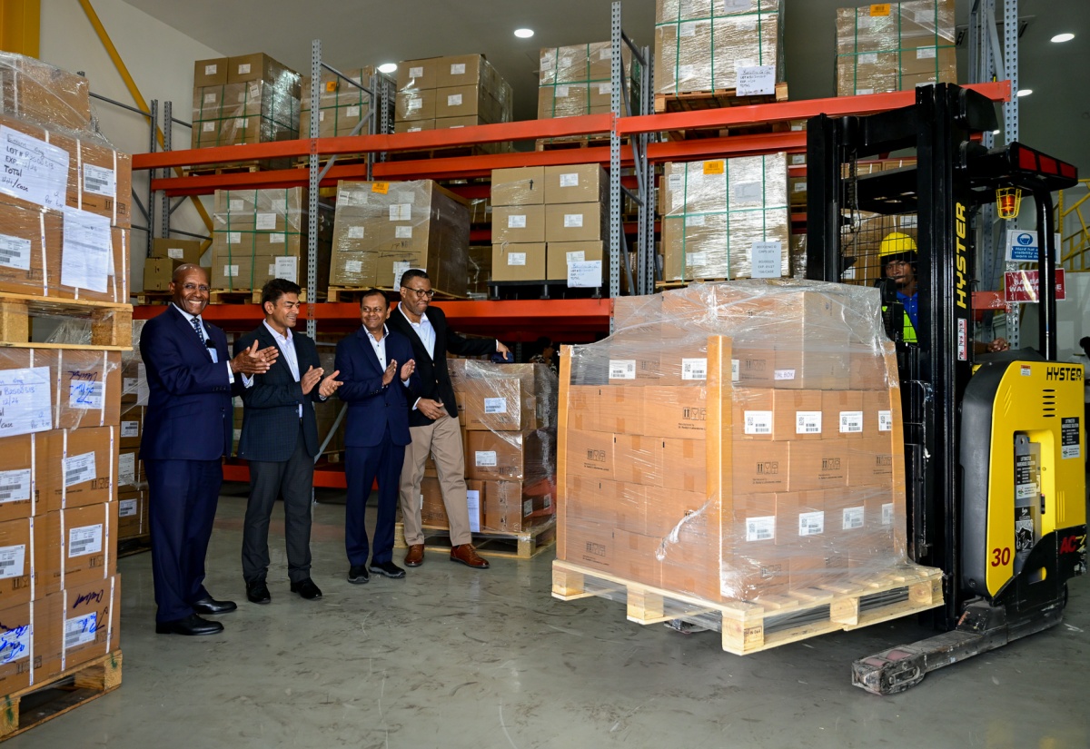 Minister of Industry, Investment and Commerce, Senator the Hon. Aubyn Hill (left), applauds as the first shipment of pharmaceutical items from Dr. Reddy’s Laboratories in Jamaica, destined for Guyana and Trinidad, is being lifted for loading on a truck.  Occasion was a tour of the Dr. Reddy’s warehouse at 109 Marcus Garvey Drive, Kingston, on Thursday (February 5). The Minister is joined by (from left) Caribbean Head, Dr. Reddy’s Laboratories, Preet Darshi Patnaik; First Attaché (Administration and Commerce) from the High Commission of India, Hansraj Chhilwar; and General Manager, T. Geddes Grant, Christopher Curtis.

