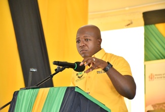 Minister of Labour and Social Security, Hon. Pearnel Charles Jr., addresses the Hanover leg of the Restoration of Owner or Occupant Family Shelters (ROOFS) handover ceremony, held at the Hanover Parish Church Hall in Lucea on Wednesday (February 25).