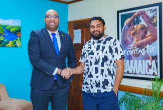 State Minister in the Ministry of Industry, Investment and Commerce, Hon. Delano Seiveright (left), greets Entertainment Entrepreneur, Romeich Major during a recent meeting focused on expanding opportunities within Jamaica’s creative industries, at the Ministry in Kingston.


