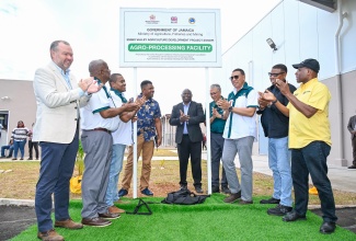 Prime Minister, Dr. the Most Hon. Andrew Holness (third right), officially hands over the state-of-the-art Essex Valley Agro-Processing and Administrative Building in St. Elizabeth, on Wednesday, February 4.  He is joined by (from left) Development Representative for Jamaica at the British High Commission, Andrew Bowden; State Minister in the Ministry of Agriculture, Fisheries and Mining, Hon. Franklin Witter; Minister of Agriculture, Fisheries and Mining, Hon. Floyd Green; Farmer, Marcus Vassell; Division Chief of Social Sector Division  at the Caribbean Development Bank, Dr. Martin Baptiste; Agro-invest CEO, Vivion Scully; President of the Essex Valley Benevolent Society, Imran Powell; and Minister of Industry, Investment and Commerce, Senator the Hon. Aubyn Hill;


