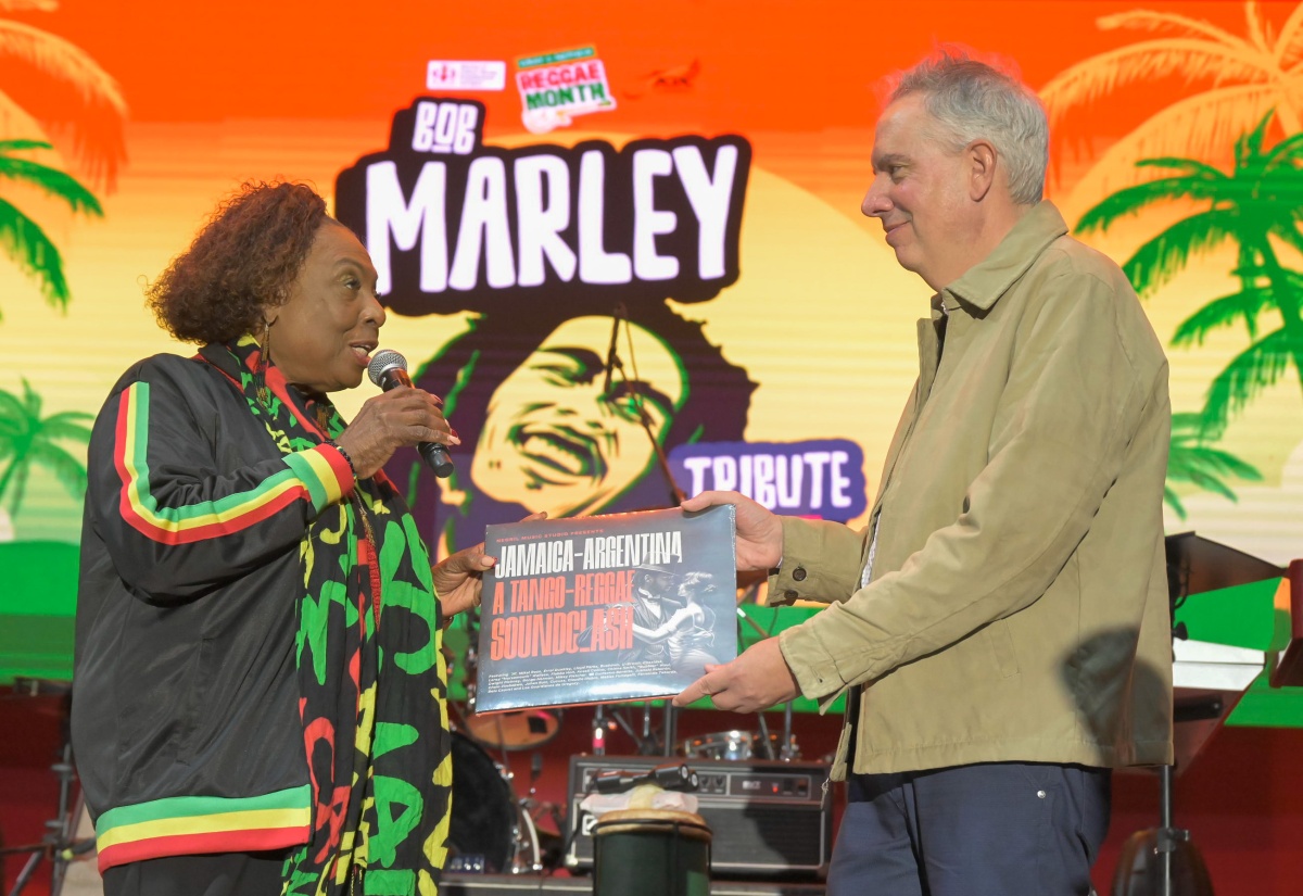 Minister of Culture, Gender, Entertainment and Sport, Hon. Olivia Grange (left), receives a vinyl token titled 