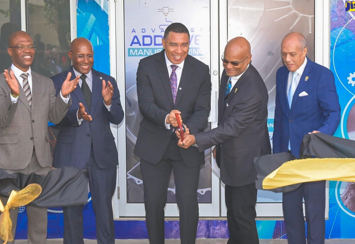 Prime Minister, Dr. the Most Hon. Andrew Holness (centre), cuts the ribbon to officially open the University of Technology (UTech) Lloyd Carney Foundation IMEK Laboratory on Tuesday (February 10), during a ceremony at the university’s Papine campus in St. Andrew. He is assisted by the University’s Chancellor and Chairman for the Foundation, Ambassador Lloyd Carney (second right). Sharing in the moment are (from left) UTech, Jamaica’s President, Dr. Kevin Brown; Minister of Industry, Investment and Commerce, Senator the Hon. Aubyn Hill, and Utech’s Pro-Chancellor, Aldrick McNab. The state-of-the-art Science, Technology, Engineering, and Mathematics (STEM) laboratory, valued over US$1 million, is a makerspace for students to design solutions for real-world problems.