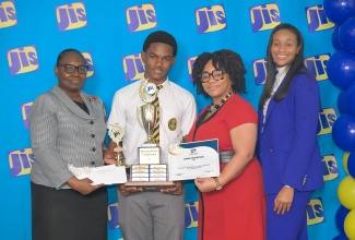 Minister of State in the Ministry of Education, Skills, Youth and Information, Hon. Rhoda Moy Crawford (right), joins Acting Chief Executive Officer of the Jamaica Information Service (JIS), Celia Lindsay (left), in presenting trophies and awards to Brian Levy, winner of the illustrated poster category in the 2025 JIS Heritage Competition, during Tuesday’s (February 17) awards ceremony at The Summit in Kingston. Sharing in the presentation is Senior Marketing Officer at First Heritage Co-operative Credit Union, Carlene Coley.