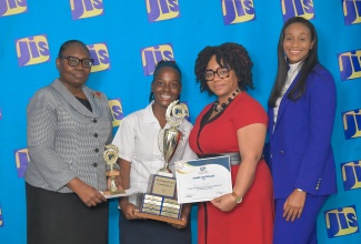 Minister of State in the Ministry of Education, Skills, Youth and Information, Hon. Rhoda Moy Crawford (right), joins Acting Chief Executive Officer of the Jamaica Information Service (JIS), Celia Lindsay (left), in presenting a trophy to Alayna Elliott (second left), winner of the digital poster category in the 2025 JIS Heritage Competition, during the awards ceremony held at the Summit Kingston on February 17. Sharing in the presentation is Senior Marketing Officer at First Heritage Co-operative Credit Union, Carlene Coley.

