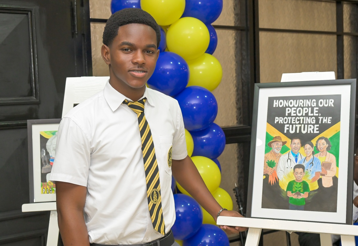 Winner of the illustrated poster category in the 2025 Jamaica Information Service (JIS) Heritage Competition, Brian Levy of York Castle High School in St. Ann, stands proudly beside his award-winning entry during Tuesday’s (February 17) ceremony at Summit Kingston.


