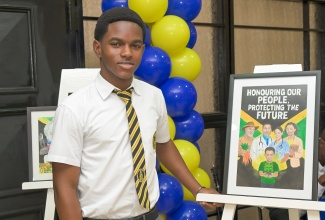 Winner of the illustrated poster category in the 2025 Jamaica Information Service (JIS) Heritage Competition, Brian Levy of York Castle High School in St. Ann, stands proudly beside his award-winning entry during Tuesday’s (February 17) ceremony at Summit Kingston.

