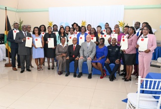Minister of Justice and Constitutional Affairs, Hon. Delroy Chuck (seated, centre), and Custos of Portland, Hon. Lincoln Thaxter (seated, second left) pause for a photo opportunity with new Justices of the Peace (JPs) for the parish and other stakeholders, during the recent commissioning ceremony held at Hotel Tim Bamboo in Port Antonio.

