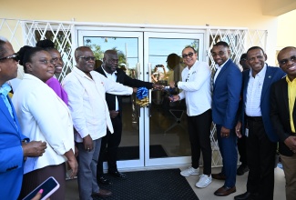 Minister of Health and Wellness, Dr. the Hon. Christopher Tufton (fourth right), cuts the ribbon to officially open the newly renovated Belfield Community Health Centre in St. Mary on February 19. He is joined by Culture, Health, Arts, Sports and Education (CHASE) Fund Board Chairman, Omar Frith (third right), and Chief Executive Officer, Wilford Heaven (second right); and National Health Fund (NHF) Institutional Benefits Manager, Collie Smith (right). Other participants (from left) are: former Member of Parliament for St. Mary South Eastern, Dr. Norman Dunn; a Belfield Community Health Centre staff member; Medical Officer of Health, St. Mary Health Services, Dr. Tamara Henry-Gilpin; Councillor for the Belfield Division, Levan Freeman, and Member of Parliament for St. Mary South Eastern, Christopher Brown.