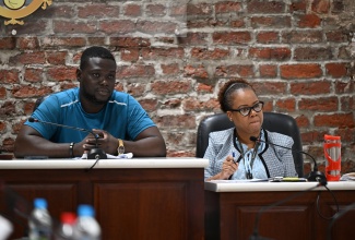 Councillor for the Oracabessa Division in St. Mary, Ramon Henry (left), chairs the Public Health and Sanitation Meeting of the St. Mary Municipal Corporation on February 24. At right is Chief Executive Officer, Ethlyn Douglas.