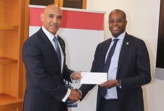 Jamaica's Ambassador to the United States (US), His Excellency Major General (Ret'd) Antony Anderson (left), receives a check in the sum of US$54,000 from interim President of Howard University, Dr. Wayne A. I. Frederick, to aid the island's hurricane-relief efforts. The presentation was made at the President’s office in Washington DC, recently. The funds were raised from a 12-hour radiothon hosted by Howard University's WHUR radio, and collections from motorists and passers-by during the event.