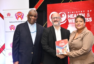 Minister of State in the Ministry of Health and Wellness, Hon. Krystal Lee (right) presents a copy of the National Strategic Plan for HIV 2023-2030, to Country Representative for the Pan-American Organization (PAHO), Ian Stein (centre), while Permanent Secretary in the Ministry, Errol Greene, shares the moment. Occasion was the launch of the Plan on Monday (February 9), at The Jamaica Pegasus hotel in New Kingston.