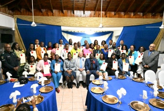 Minister of Justice and Constitutional Affairs, Hon. Delroy Chuck (seated, centre), is pictured with the 31 newly appointed Justices of the Peace (JPs) for Westmoreland during the commissioning ceremony at the Commingle Hotel in Savanna-la-Mar on January 29.