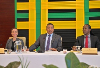 Prime Minister, Dr. the Most Hon. Andrew Holness (centre), addresses Heads of Jamaica’s diplomatic and consular missions at the Ministry of Foreign Affairs and Foreign Trade in downtown Kingston on Wednesday (February 11). He is flanked by Portfolio Minister, Senator the Hon. Kamina Johnson Smith, and State Minister, Hon. Alando Terrelonge.