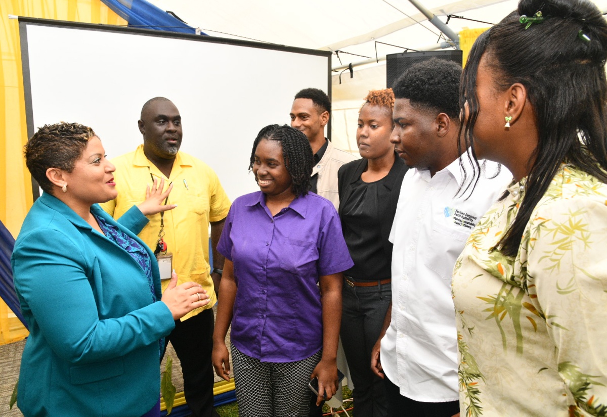 Minister of State in the Ministry of Health and Wellness, Hon. Krystal Lee (left), commends Southern Regional Health Authority (SRHA) staff, who designed the new Computerised Maintenance Management System, following the launch at the SRHA offices in Mandeville, Manchester, on Thursday (February 5). They are (from second left) Rohan Smith, Toni-Ann Rodney, Ryan Dixon, Saede Nisbeth, O