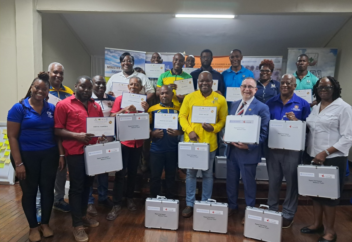 Minister of State in the Ministry of Agriculture, Fisheries and Mining, Hon. Franklin Witter (second right, front row); Canada’s High Commissioner to Jamaica, His Excellency Mark Berman (third right, front row); Senior Director of the Agricultural Land Management Division, Joan Brown-Morrison (right, front row); and Country Coordinator for the World University Service of Canada (WUSC) Caribbean, Nelsa English-Johnson (left, front row), share a photo opportunity with members of the Rural Agricultural Development Authority (RADA) who successfully completed a recent soil management training programme. The initiative was implemented through a partnership between the Agriculture Ministry and the WUSC) Caribbean, with funding from the Government of Canada. The group displays soil testing kits received during the closing ceremony, held on Tuesday (February 17) at the Liguanea Club in New Kingston.