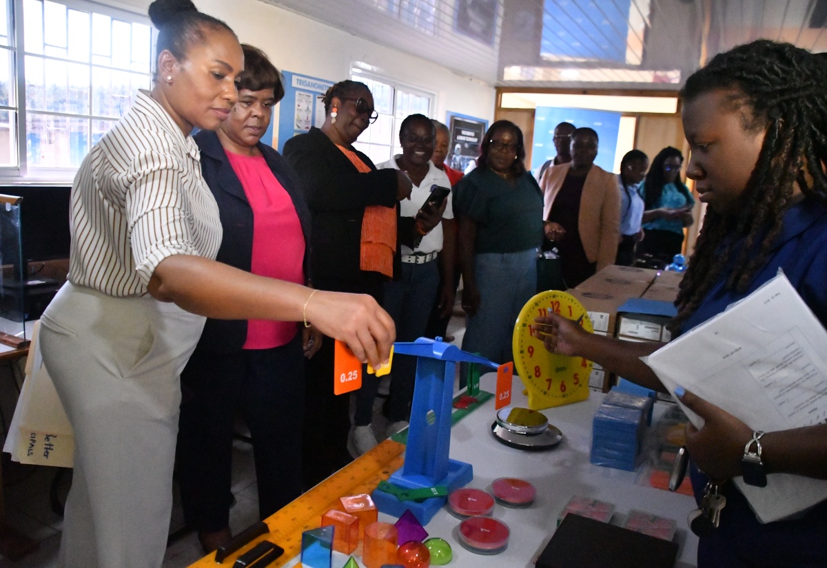 Regional Director at the Ministry of Education, Skills, Youth and Information – Region Four, Dr. Michele Pinnock (second left), looks on as Senior Education Officer, Jacqueline Gardiner (left), along with other senior educators, engage with mathematical teaching aids during the official opening of the Maud McLeod High School Resource Hub in Darliston, Westmoreland, on February 19. The Hub was established through a partnership involving the Ministry of Education, the Liberty Caribbean Foundation, and the Flow Foundation to strengthen teaching and learning continuity in eastern Westmoreland.

