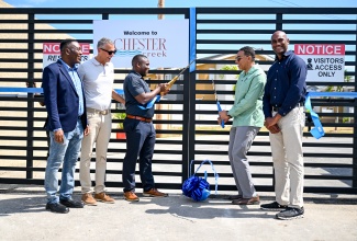 Prime Minister, Dr. the Most Hon. Andrew Holness (second right), and Chief Executive Officer (CEO) of West Indies Home Contractors Limited (WIHCON), Marvin Campbell (third left), cut the ribbon to launch the Chester Creek housing development at Westchester Drive in Portmore, St. Catherine, on Tuesday (March 3). Sharing in the moment are (from left) Councillor for Westchester Division, Renair Benjamin, representing Mayor of Portmore, Leon Thomas; Chairman of WIHCON,  Peter Melhado, and Member of Parliament for St. Catherine South Eastern, Dr. Alfred Dawes. 

