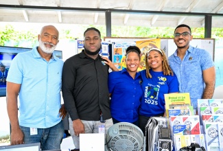The team from the Jamaica Information Service (JIS) shares a photo opportunity at the St. Catherine High School's annual health fair held at the institution on March 20. They are (from left) Driver, Michael Samuels; Computer Services System Administrator (Acting), Jaleel Powell; Web Developer/Designer, Abbagay Richards; Special Projects Officer, Romona Geohaghan, and Special Projects Manager, Paul Allen. The team provided information about JIS's service offerings and issued health-related brochures on topics such as mental health awareness, cancer awareness, how to make a will, and others. 
