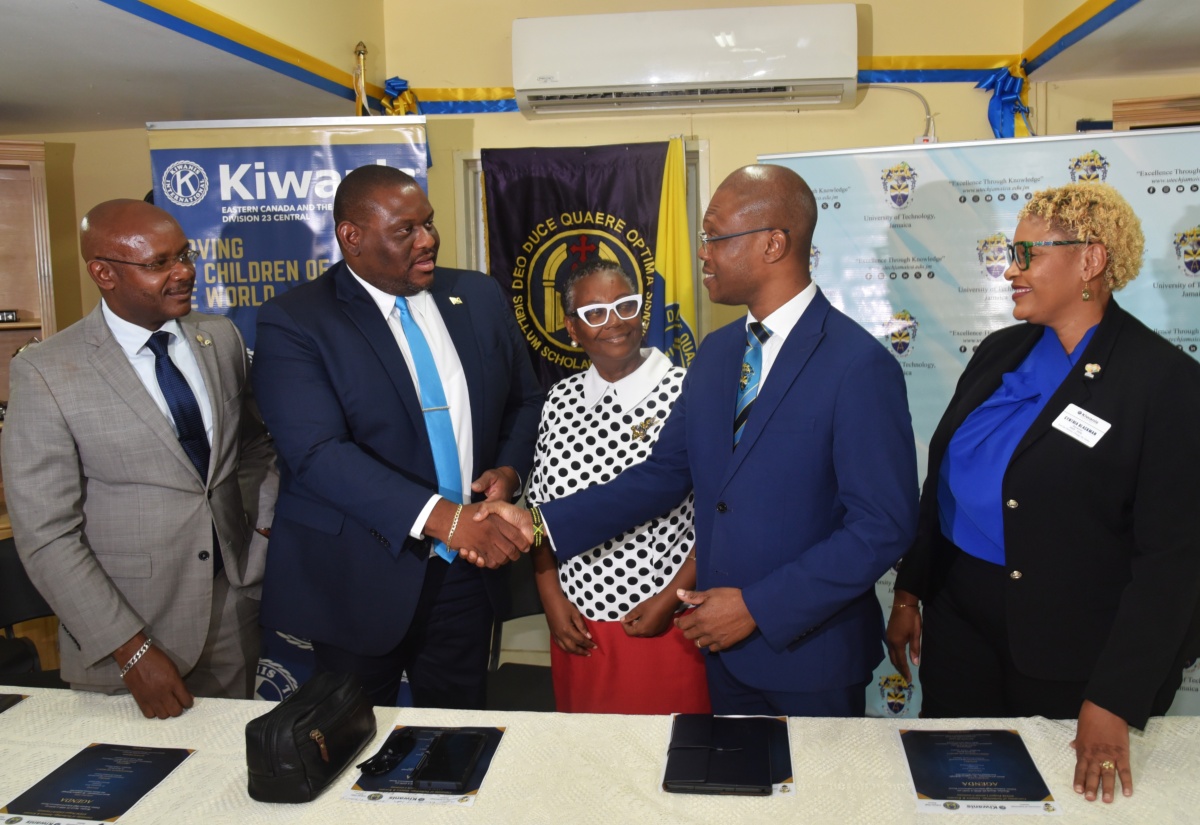 Parliamentary Secretary in the Ministry of Education Skills Youth and Information, Senator Marlon Morgan (second left), shakes hands with President, University of Technology (UTech), Dr. Kevin Brown (second right), following the launch of the UTech and Kiwanis Club Science, Technology, Engineering and Mathematics (STEM) Project on Monday (March 23), at Ardenne High School in St. Andrew.  Sharing in the moment are (from left) Lieutenant Governor, Kiwanis Division 23 Central, Michael Powell; Principal, Ardenne High School, Dr. Jacqueline Pinto; and District Governor, Kiwanis Eastern Canada and Caribbean, Cynthia Blackman. 