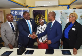 Parliamentary Secretary in the Ministry of Education Skills Youth and Information, Senator Marlon Morgan (second left), shakes hands with President, University of Technology (UTech), Dr. Kevin Brown (second right), following the launch of the UTech and Kiwanis Club Science, Technology, Engineering and Mathematics (STEM) Project on Monday (March 23), at Ardenne High School in St. Andrew.  Sharing in the moment are (from left) Lieutenant Governor, Kiwanis Division 23 Central, Michael Powell; Principal, Ardenne High School, Dr. Jacqueline Pinto; and District Governor, Kiwanis Eastern Canada and Caribbean, Cynthia Blackman. 
