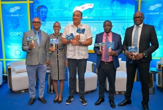 Minister of Health and Wellness, Dr. the Hon. Christopher Tufton (centre), leads the celebration while speaking at the launch of the National Health Fund (NHF) expansion of health benefits, today (March 18), at the Spanish Court Hotel in St. Andrew. Others pictured (from left) are Deputy Chairman of the NHF, Michael Stern; President-elect of the Medical Association of Jamaica (MAJ), Dr. Mindi Fitz-Henley; Chief Executive Officer of the NHF, Everton Anderson, and Senior Director at the agency, Ainsley Jones.