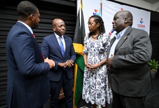 Minister of Labour and Social Security, Hon. Pearnel Charles Jr. (second, left), engages in a discussion with Director General at the Office of Disaster Preparedness and Emergency Management (ODPEM), Commander Alvin Gayle (left); Executive Director of the Caribbean Disaster Emergency Management Agency (CDEMA), Elizabeth Riley (second, right); and United Nations (UN) Resident Coordinator for Jamaica, Dennis Zulu. The interaction took place during the opening ceremony of the regional after-action review (AAR) workshop on Hurricane Melissa at the S Hotel in Kingston on Tuesday (March 10).

