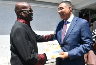 Prime Minister, Dr. the Most Hon. Andrew Holness (right), is greeted by Bishop Dr. Herro Blair at the Faith Cathedral Deliverance Centre in Kingston on Sunday (March 22). Dr. Holness delivered greetings at the 50th anniversary celebrations of the Deliverance Evangelistic Association.


