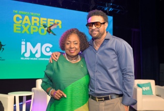 Minister of Culture, Gender, Entertainment and Sport, Hon. Olivia Grange, shares a moment with Chairman and Co-founder of the Island Music Conference (IMC), and internationally acclaimed recording artiste, Orville “Shaggy” Burrell, during the fifth staging of the Jamaica Creative Career Expo, held recently at the Courtleigh Auditorium in Kingston under the theme 'Careers in Music, Media, Publishing’.
