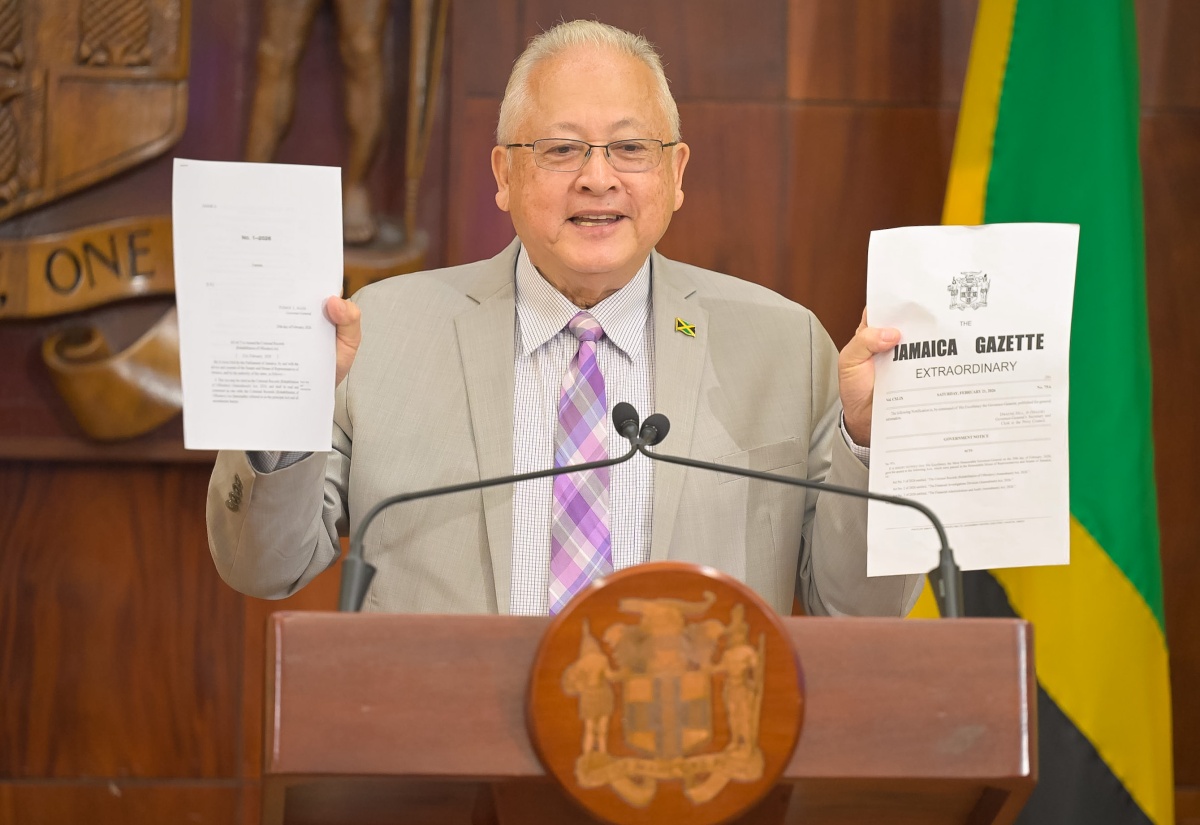 Minister of Justice and Constitutional Affairs, Hon. Delroy Chuck, displays a copy of the Criminal Records (Rehabilitation of Offenders) (Amendment) Act, 2026 and its accompanying Jamaica Gazette, during Wednesday’s (March 4) post-Cabinet Press Briefing at Jamaica House.

