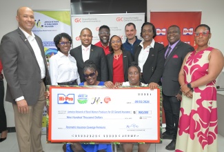 Minister of Agriculture, Fisheries and Mining, Hon. Floyd Green (third left, second row), joins a photo opportunity as Hi-Pro presents a symbolic cheque to members of the Jamaica Network of Rural Women Producers (JNRWP) during the Roots Resilience Parametric Insurance Programme handover ceremony, held on Monday (March 9) at GraceKennedy (GK) General Insurance Company’s New Kingston office. Also pictured (from left) are Hi-Pro Vice-President, Colonel (Ret’d) Jamie Ogilvie; JNRWP Executive Board Member, Marva Allen-Simms; GK General Insurance Client and Partner Services Manager, Orette Duncan; GK Group’s Head of General Insurance, Tammara Glaves-Hucey; CARE Caribbean Humanitarian Response Lead, Jonathan Arogeti; GK General Insurance Assistant General Manager for Client and Partner Services, Andrea Muir-Gibbs; and JNRWP Consultant, Christopher Chinapoo. The initiative will benefit 120 women producers, supported by a US$65,000 pledge from CARE International and a $900,000 commitment from Hi-Pro, and is facilitated through the GK Weather Protection Programme.

