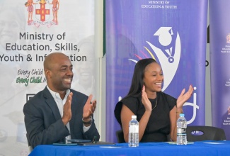 State Minister in the Ministry of Education, Skills, Youth and Information, Hon. Rhoda Moy Crawford, together with Education Transformation Oversight Committee (ETOC) Chairman, Dr. Adrian Stokes, congratulated a grade-two student for posing a question during Thursday’s (March 26) ETOC press conference at Shortwood Teachers’ College in St. Andrew.