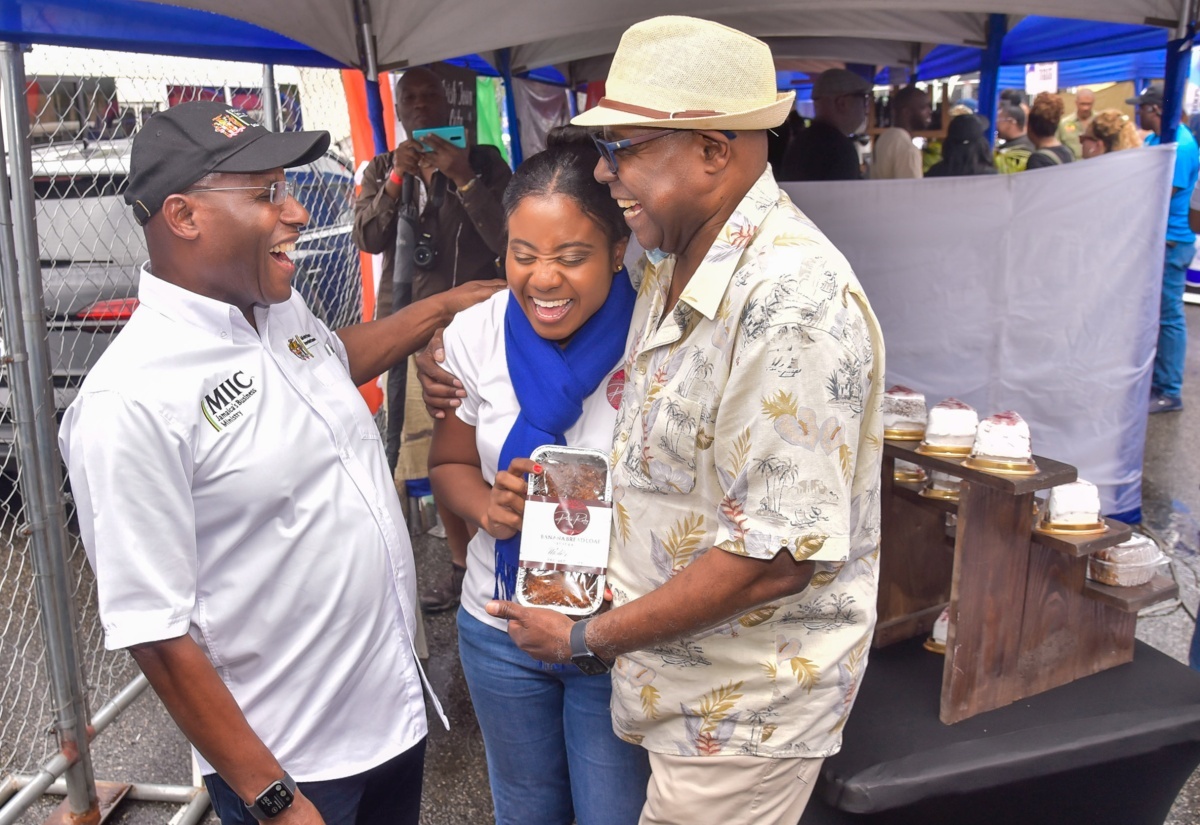 Tourism Minister, Hon. Edmund Bartlett (right), and Minister of Industry, Investment and Commerce, Hon. Aubyn Hill (left), share a light moment with Owner, Paris Ruby Gourmet, Zelecia Smith, while visiting her booth during a previous staging of the Jamaica Blue Mountain Coffee Festival.


