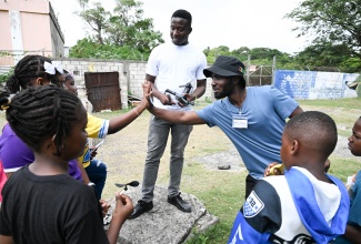 Instructors lead a drone flying session with students at the Morant Bay Primary School on March 7 as part of the DC Mentorship Program