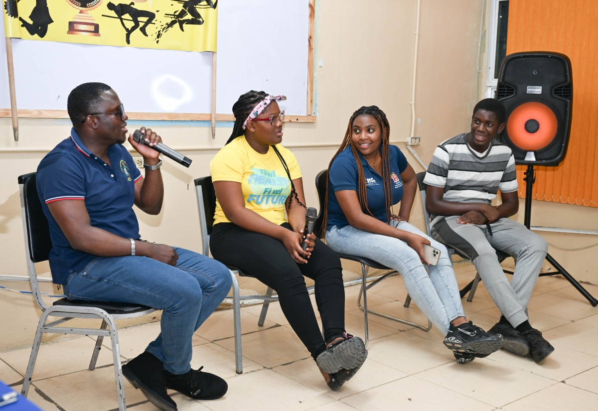 Police Youth Club (PYC) Coordinator for the St. Thomas Division and member of the Community Safety and Security Unit, Constable Roger Douglas (left), and (from second left), Breanna Harrison, Daneila Morgan, and Ricardo Buckley, engage in a panel discussion during the launch of Next Gen Talk, a podcast, by the St. Thomas PYC Movement on March 21, at the Morant Bay Police Station.

