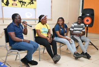 Police Youth Club (PYC) Coordinator for the St. Thomas Division and member of the Community Safety and Security Unit, Constable Roger Douglas (left), and (from second left), Breanna Harrison, Daneila Morgan, and Ricardo Buckley, engage in a panel discussion during the launch of Next Gen Talk, a podcast, by the St. Thomas PYC Movement on March 21, at the Morant Bay Police Station.

