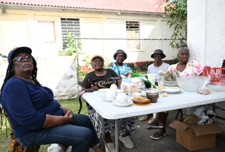 Senior citizens man a table with items for sale during their regular Friday sale at the Anglican Church Hall in Morant Bay, St. Thomas, on March 6.

